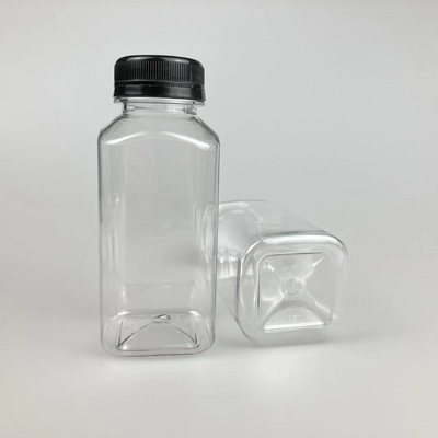 Izolowane plastikowe butelki na herbatę z mlekiem ze śrubą na pokrywie i uchwytzie